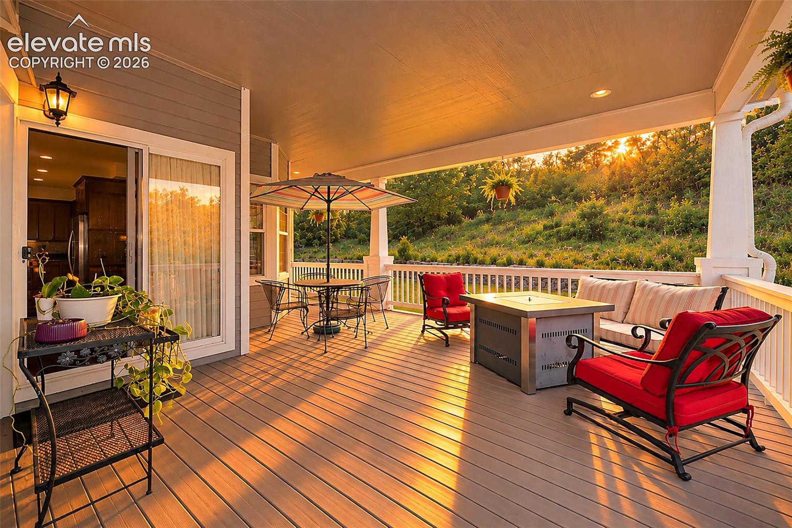 Expansive covered composite deck off kitchen with mountain views