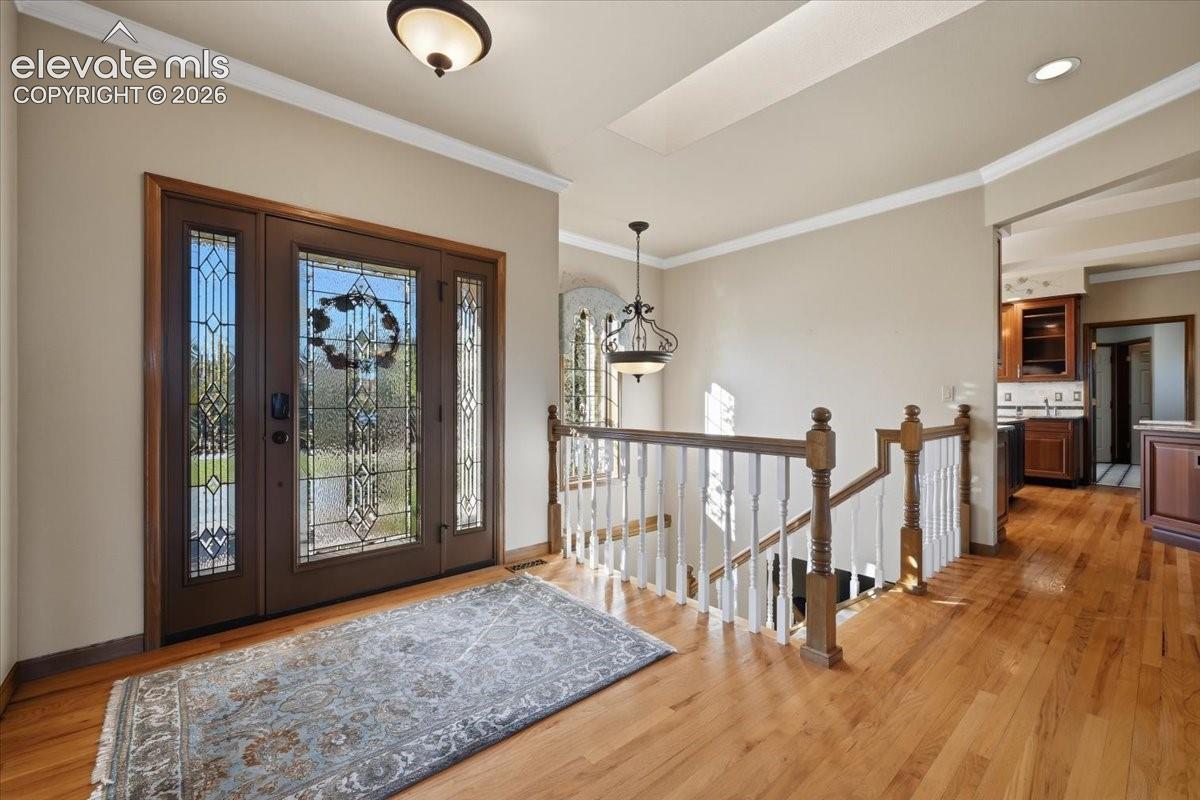 Stunning glass door entrance welcomes guests. 