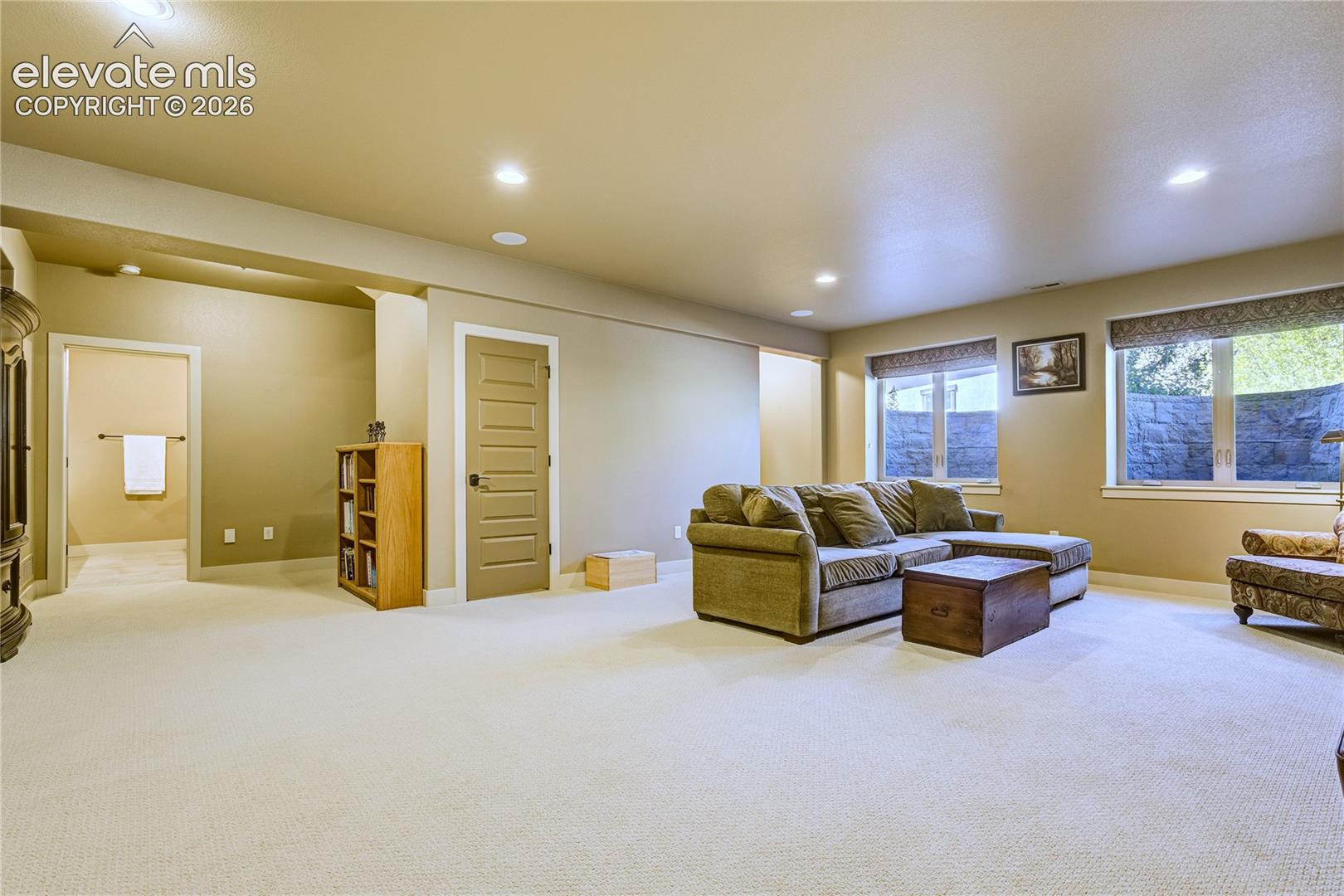 The finished garden level offers flexible space for entertaining, hobbies or fitness, with generous windows bringing natural light into this inviting second living area.