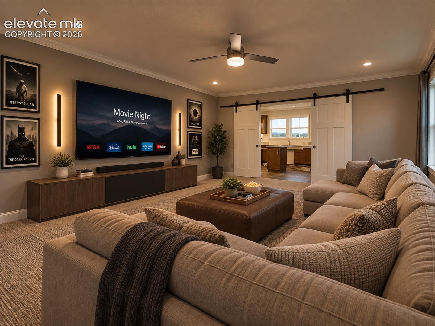 Spacious family room offers plenty of room for comfortable seating and entertainment, with wide sliding barn doors providing direct access to the adjoining laundry and flex space.