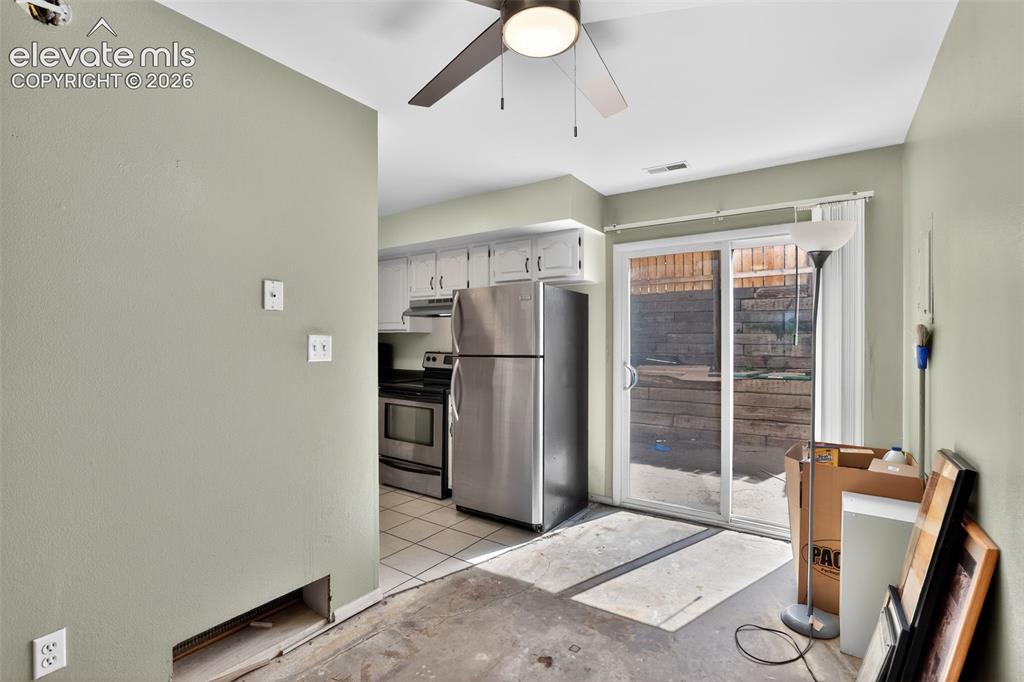 Kitchen area featuring white cabinetry and stainless steel appliances