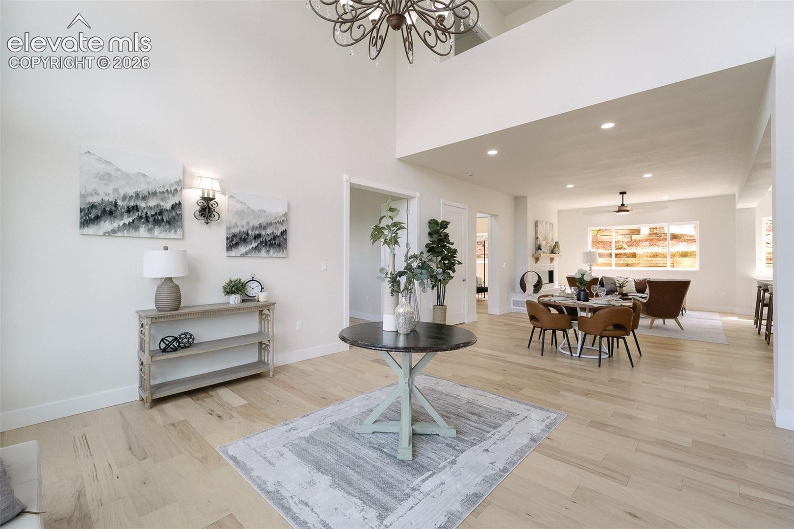 The Living Room has soaring ceilings and flows into the Dining Area and Great Room.