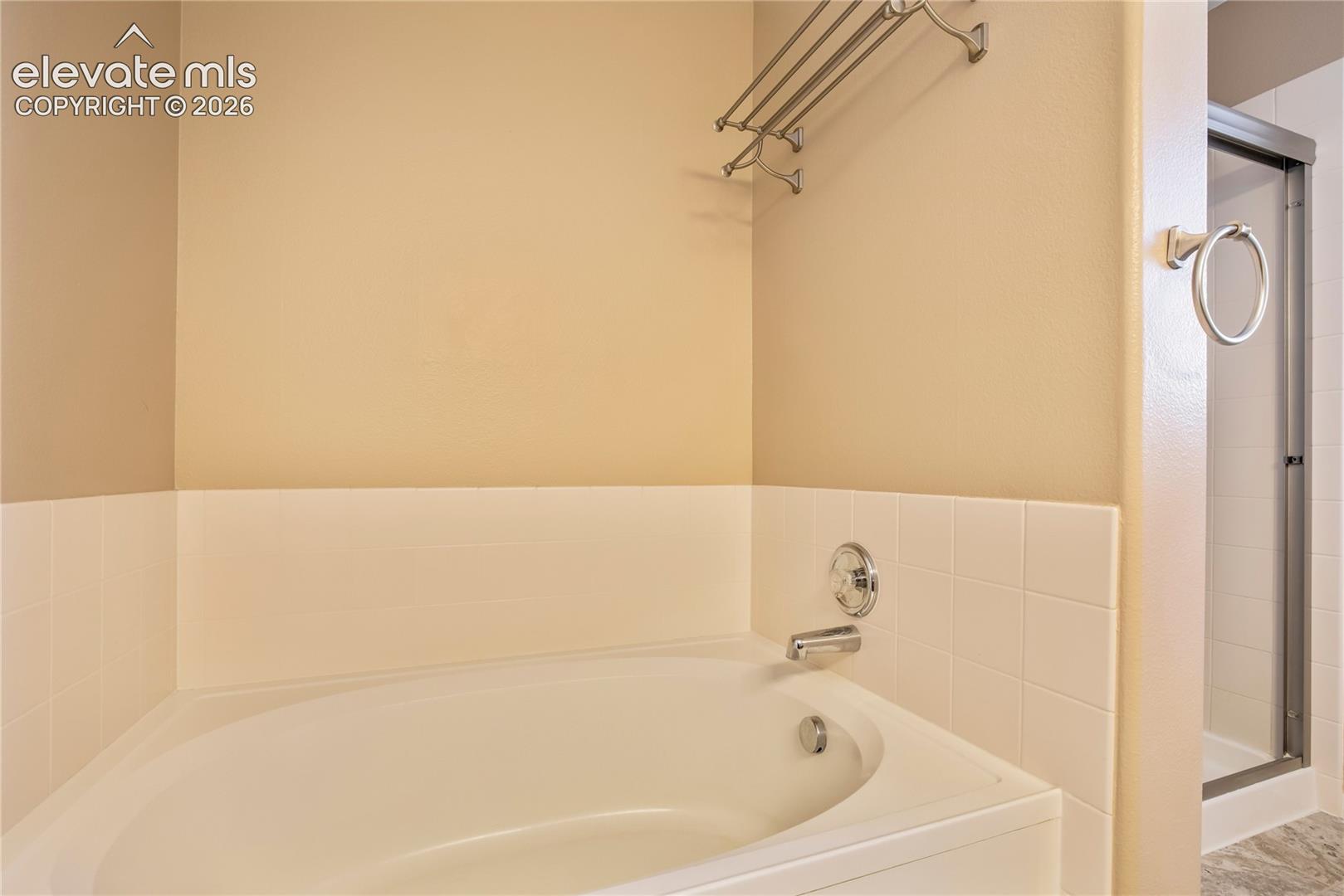 Relax in the soaking tub, with a separate shower completing the primary suite's spacious 5-piece bath.
