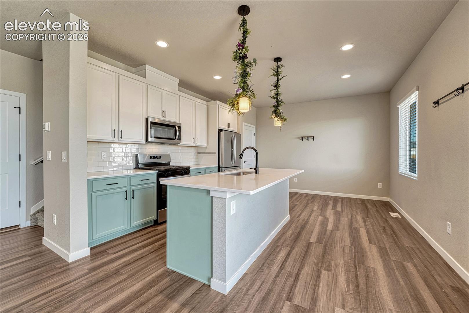 Kitchen offers a large island, pantry, stainless steel appliances...