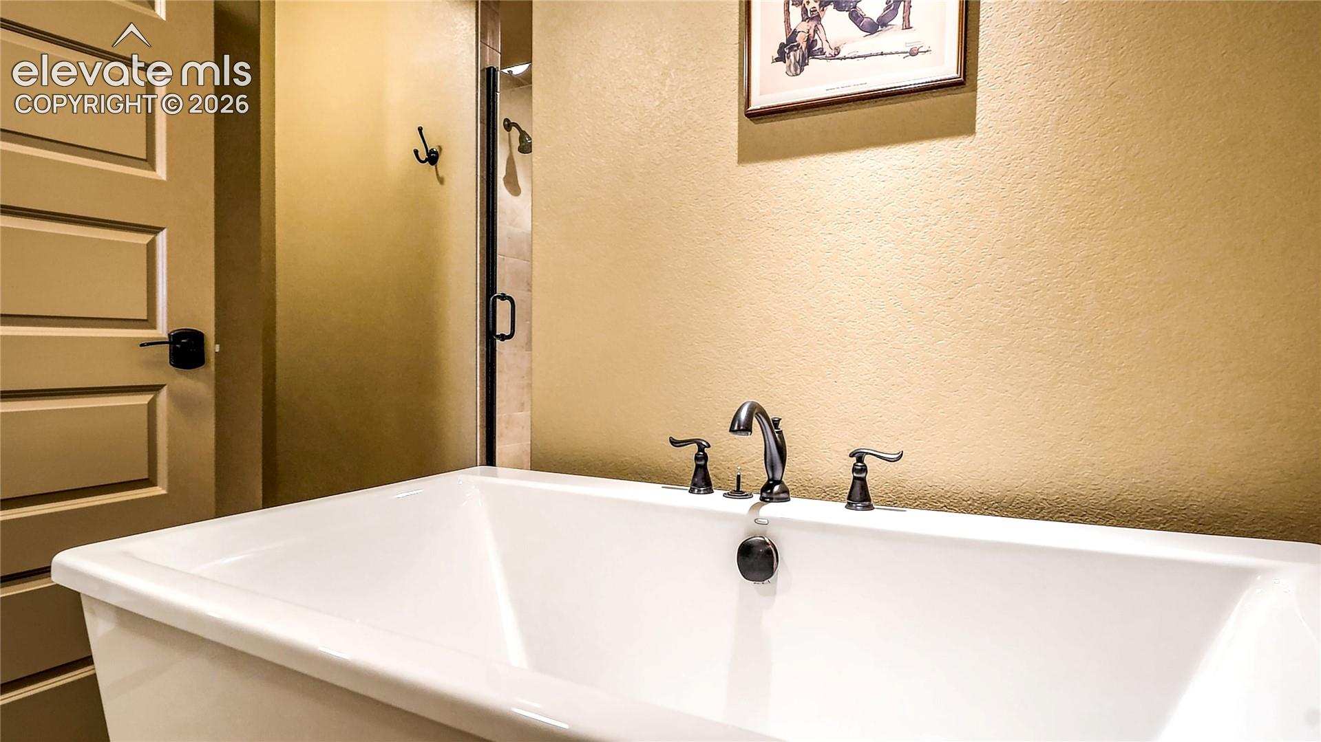 A separate soaking tub adds a welcome touch of relaxation to the garden-level bathroom, creating a comfortable, well-appointed retreat for guests or extended stays.