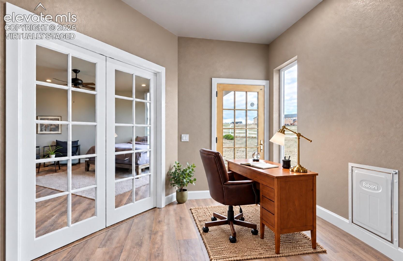 Virtually Staged Wood-finish flooring with a textured area rug