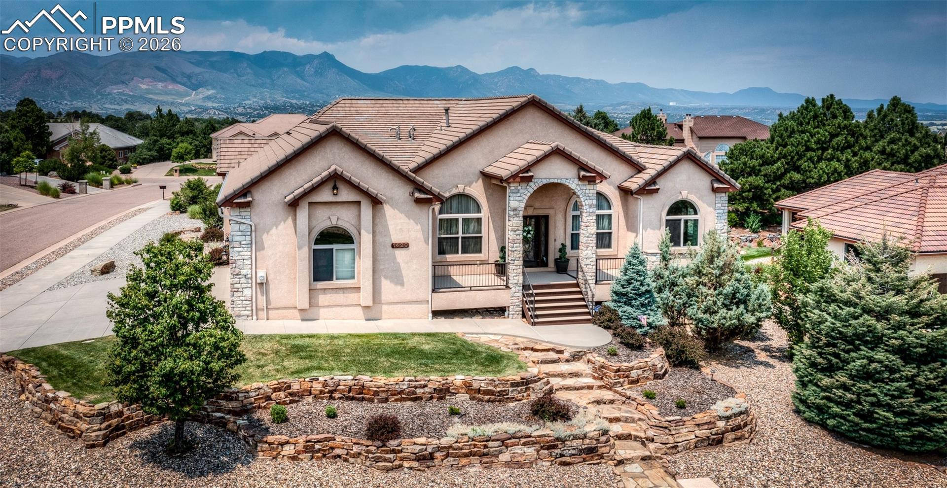 Immaculate updated 4,780 sq ft 7 bedroom stone & stucco raised rancher on a beautiful professionally landscaped corner lot at the top of University Heights.  Tile roof ~ 2 Fireplaces ~ 2 Security systems with cameras inside & outside plus fire alarm system ~ Extensive 12' entry ceiling & natural 12' coffered ceilings in formal living & dining rooms~ glistening natural hickory floors with Brazilian cherry inlaids throughout the main level living areas ~ Gourmet granite & stainless steel kitchen totally redone in 2022 to include a gas range & dual ovens, soft close drawers & pull outs even in the pantry~ total one level living with laundry, primary suite & 3 more bedrooms on the main level ~ Elegant primary 5 piece bath with heated tile floor, jetted tub, granite counters & a 14' curved walk in shower with dual shower heads & glass block accents ~ Central vac ~ A/C & humidifier on main level.  Huge 2nd family room in walk out basement with granite topped wet bar with 2nd fridge ~ 10'-12' ceilings on main level & 9' ceilings in basement ~ Milgard windows ~ Finished & painted 3 car garage with custom overhead doors, epoxy floor covering, high ceilings & a south facing driveway ~ 17x17 rear composite  partially covered deck ~ 28x8 front composite partially covered deck both with powder coated iron railings ~ 12x10 patio off walk out basement ~ City views from the front and some mountain & Pikes Peak view from the rear.  Immaculate condition. No kids, pets or smoking here.  Shows great.