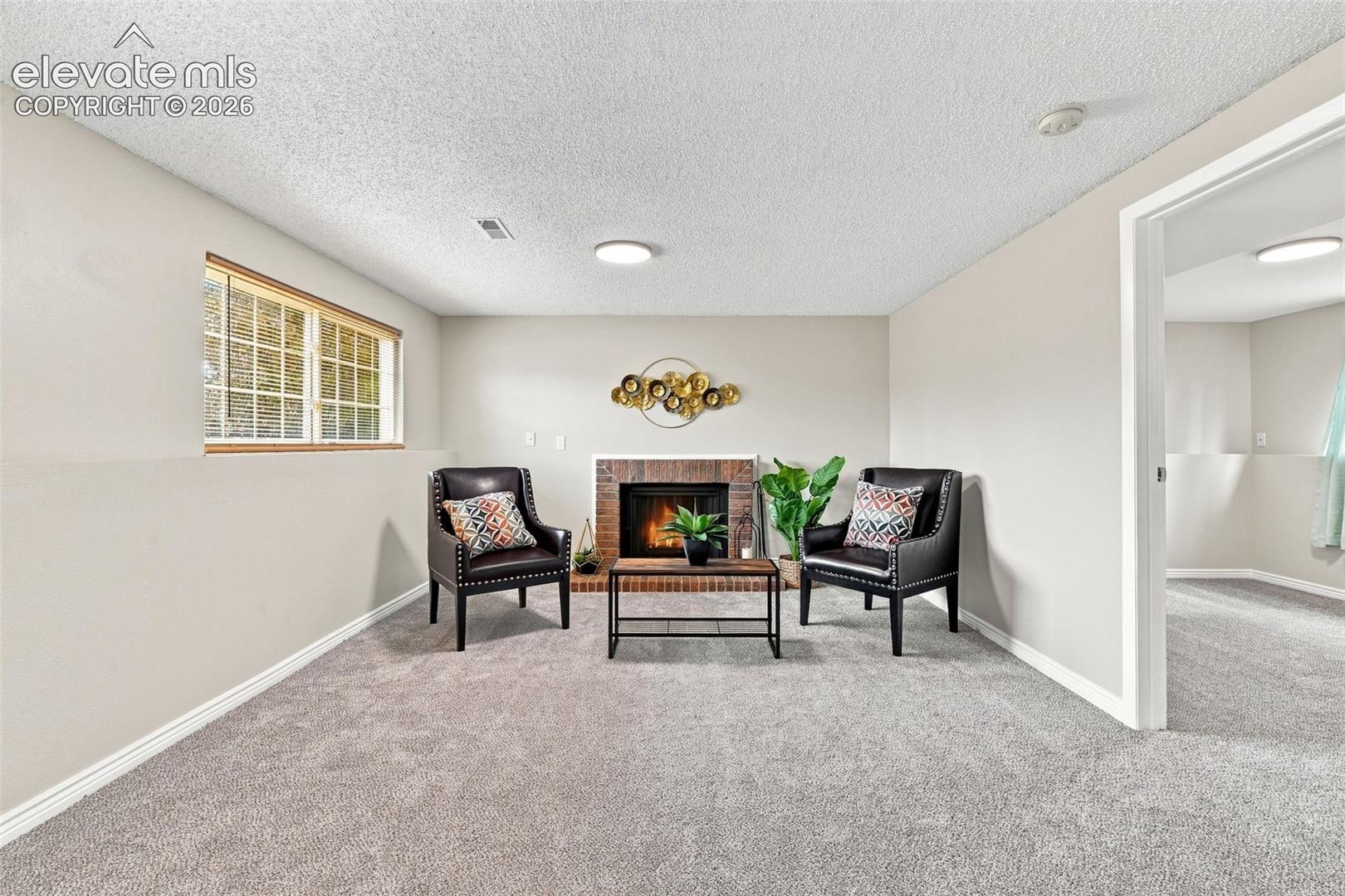 Lower Level Family room area around wood burning fireplace.