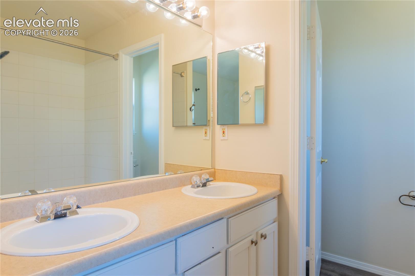 Extended dual-sink vanity with abundant counter space and storage.