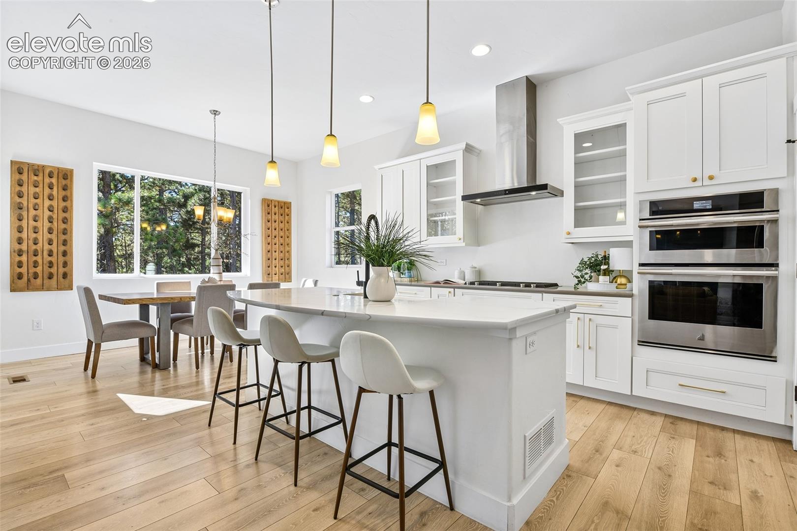 Open to dining area with wooded views