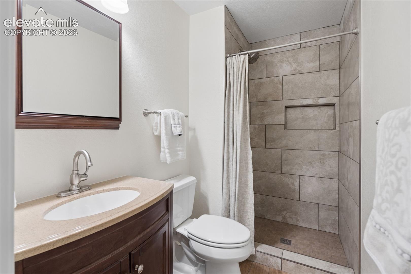 Ensuite primary bathroom w/newly tiled walk-in shower