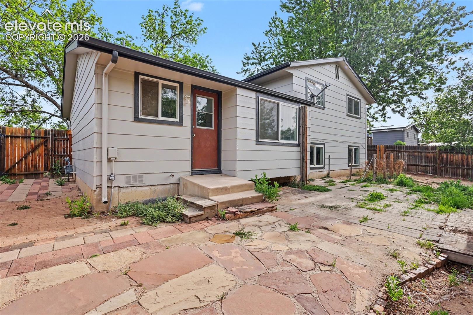 Fenced backyard with patio space and room to personalize over time.