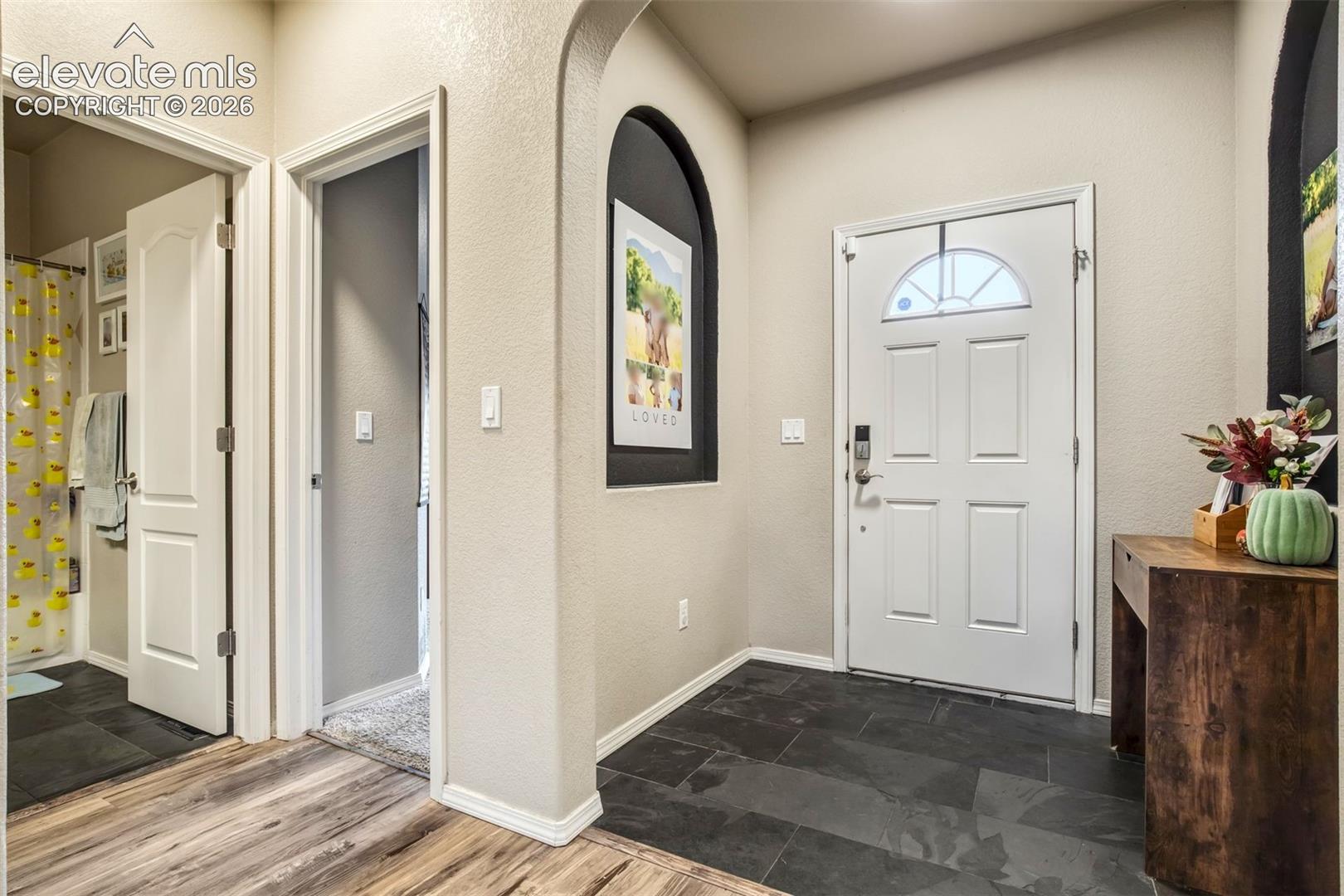 Linen closet, full bathroom and front bedroom to the right upon entering 