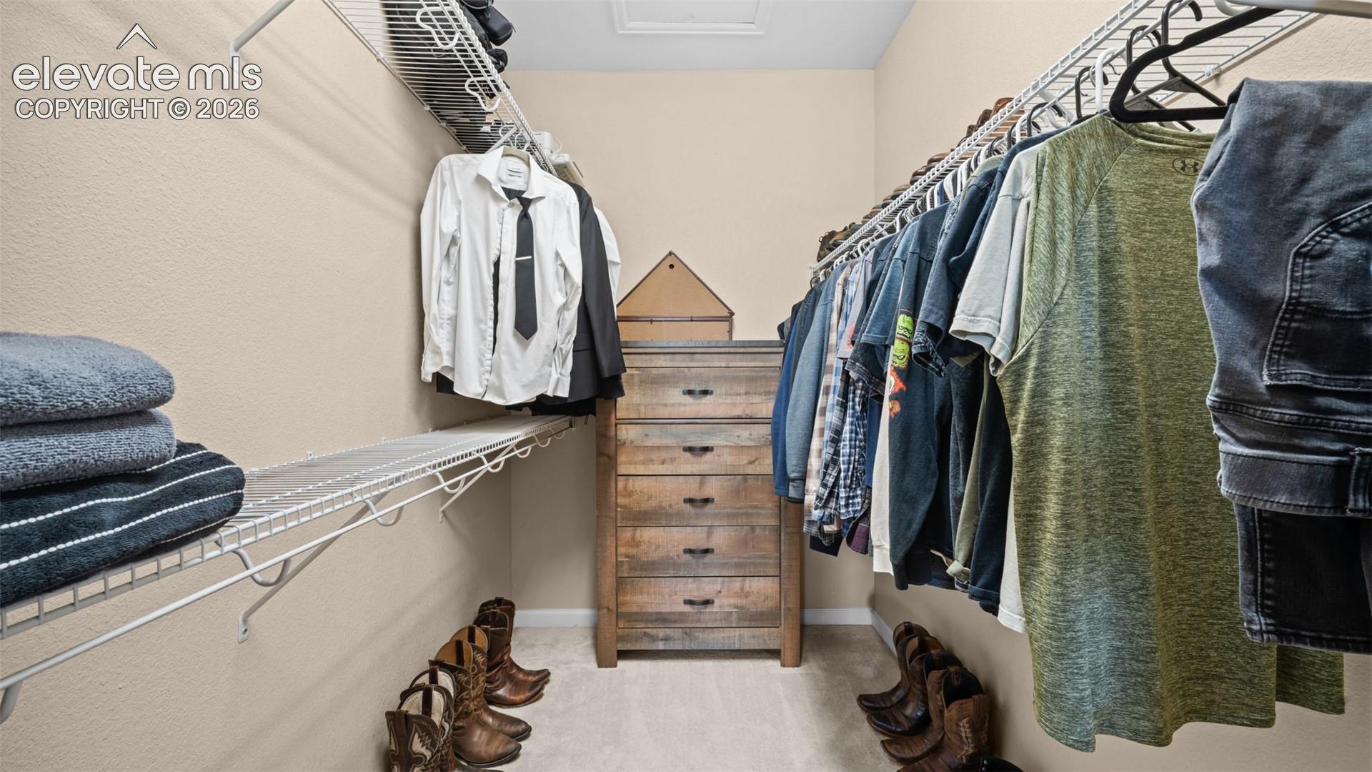 Walk-in closet featuring wire shelving, hanging rods, and light-toned wall paint