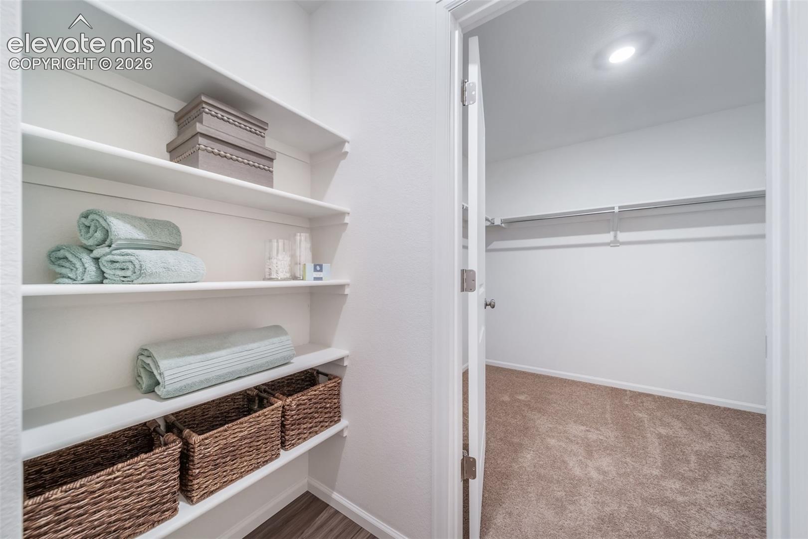White shelving system with wood-finish flooring
*photos of a model home*