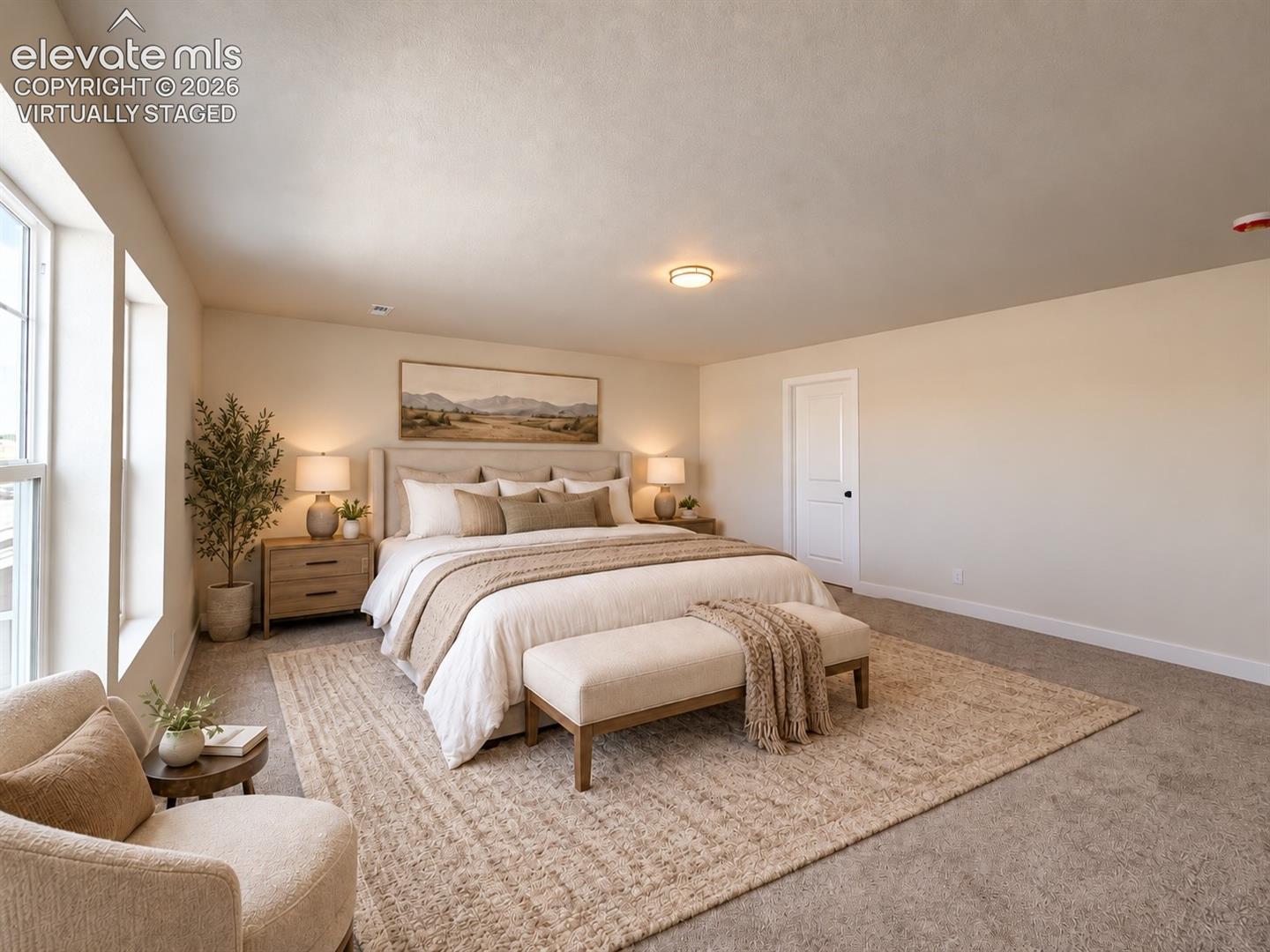 bedroom with upholstered bed, bench, neutral rug, large picture above headboard, and windowed sitting nook — virtually staged