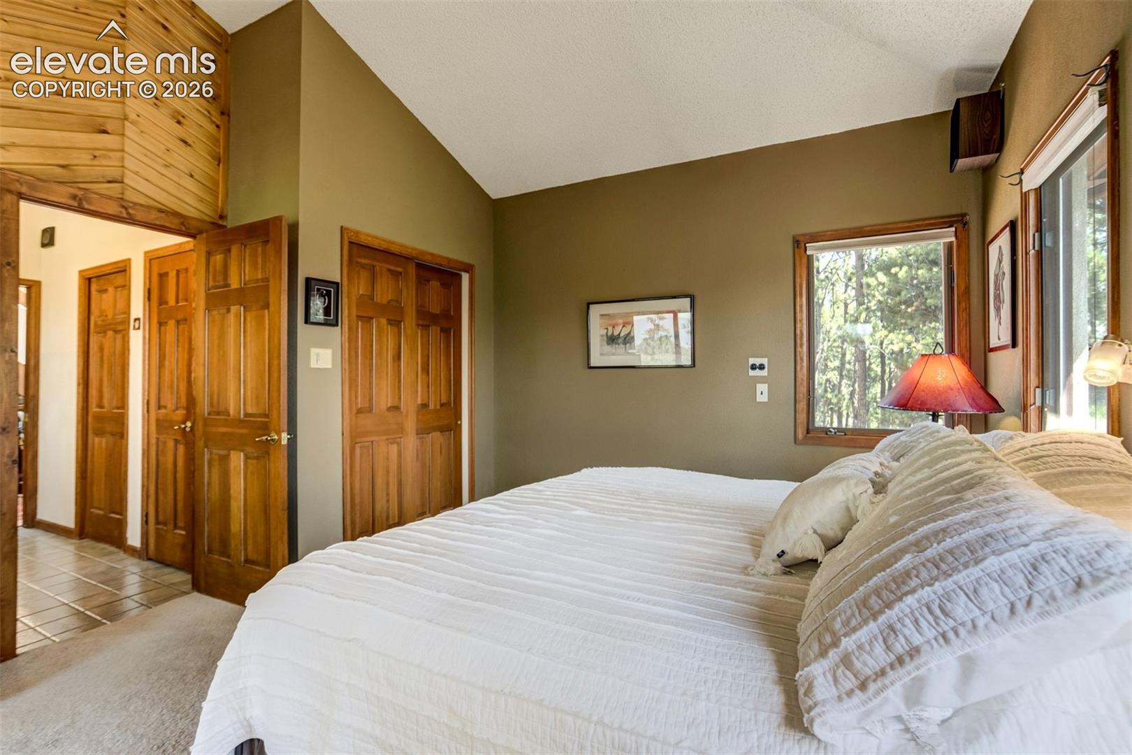 Main level primary bedroom with attached bath and dual closets