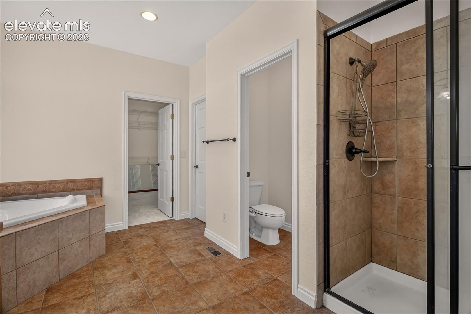 Spacious Bathroom With Soaking Tub And Free Standing Shower
