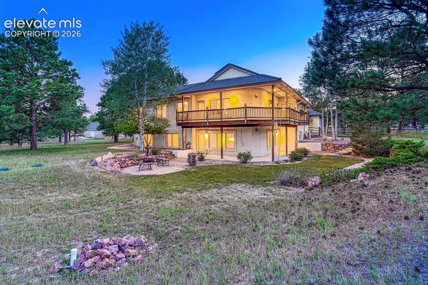 Sunset view of the rear of the home and patios.