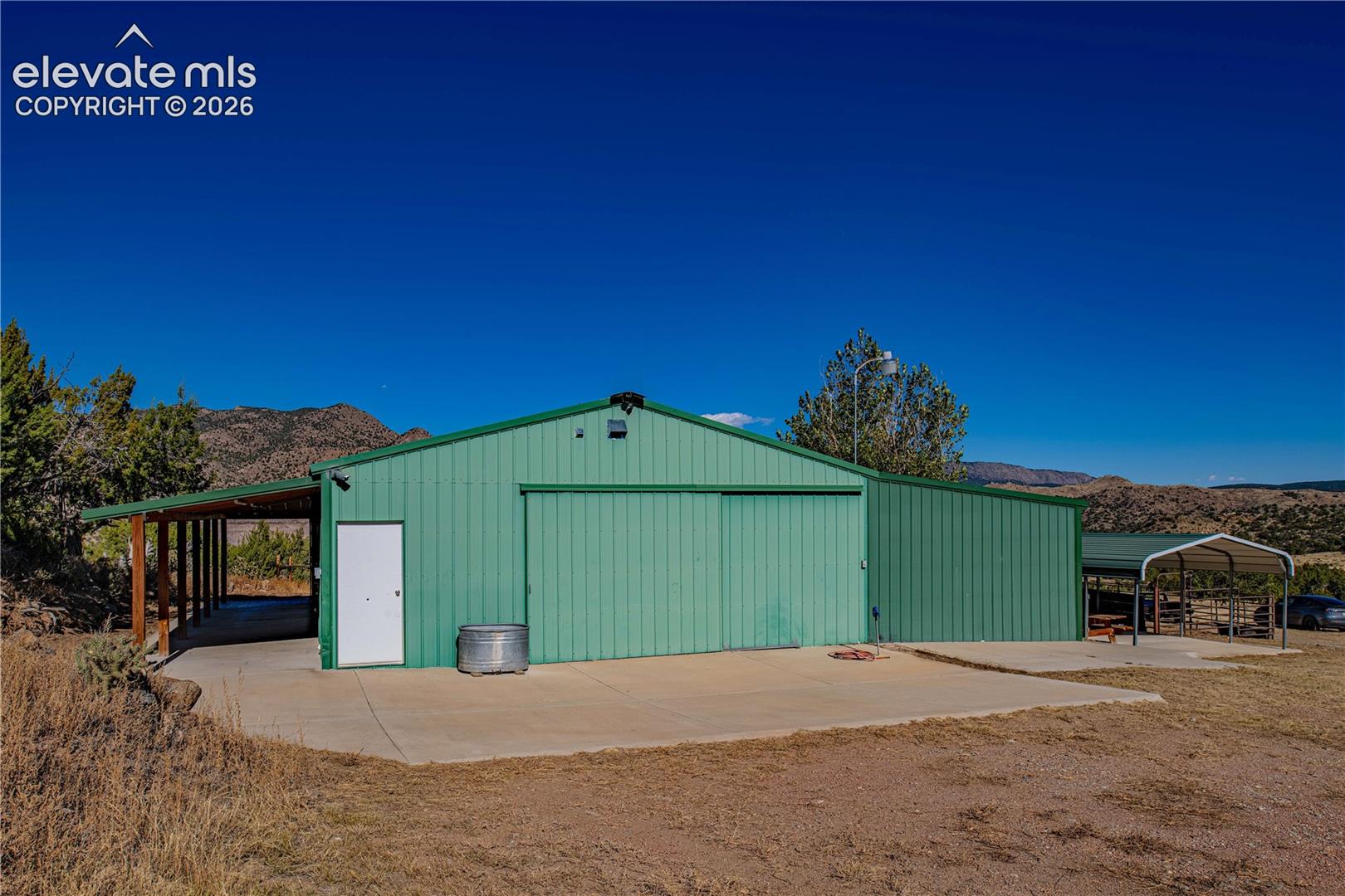 View of outdoor structure with a mountain view and a carport