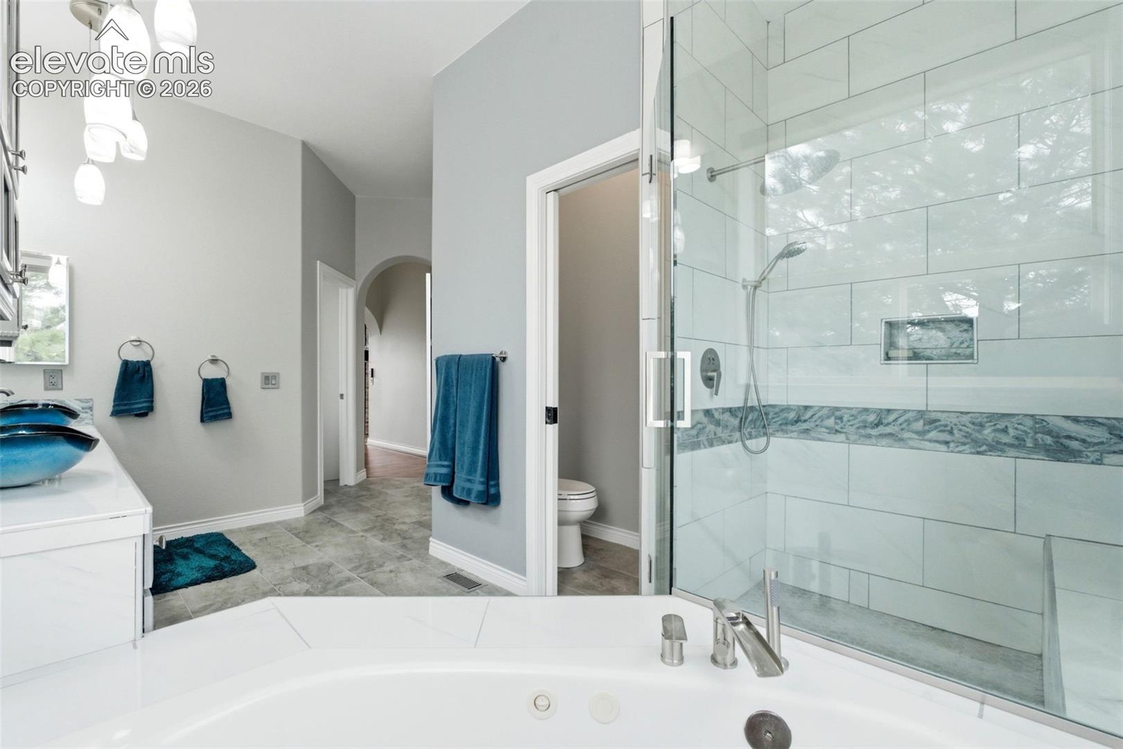 Corner soaking tub with deck-mounted faucet