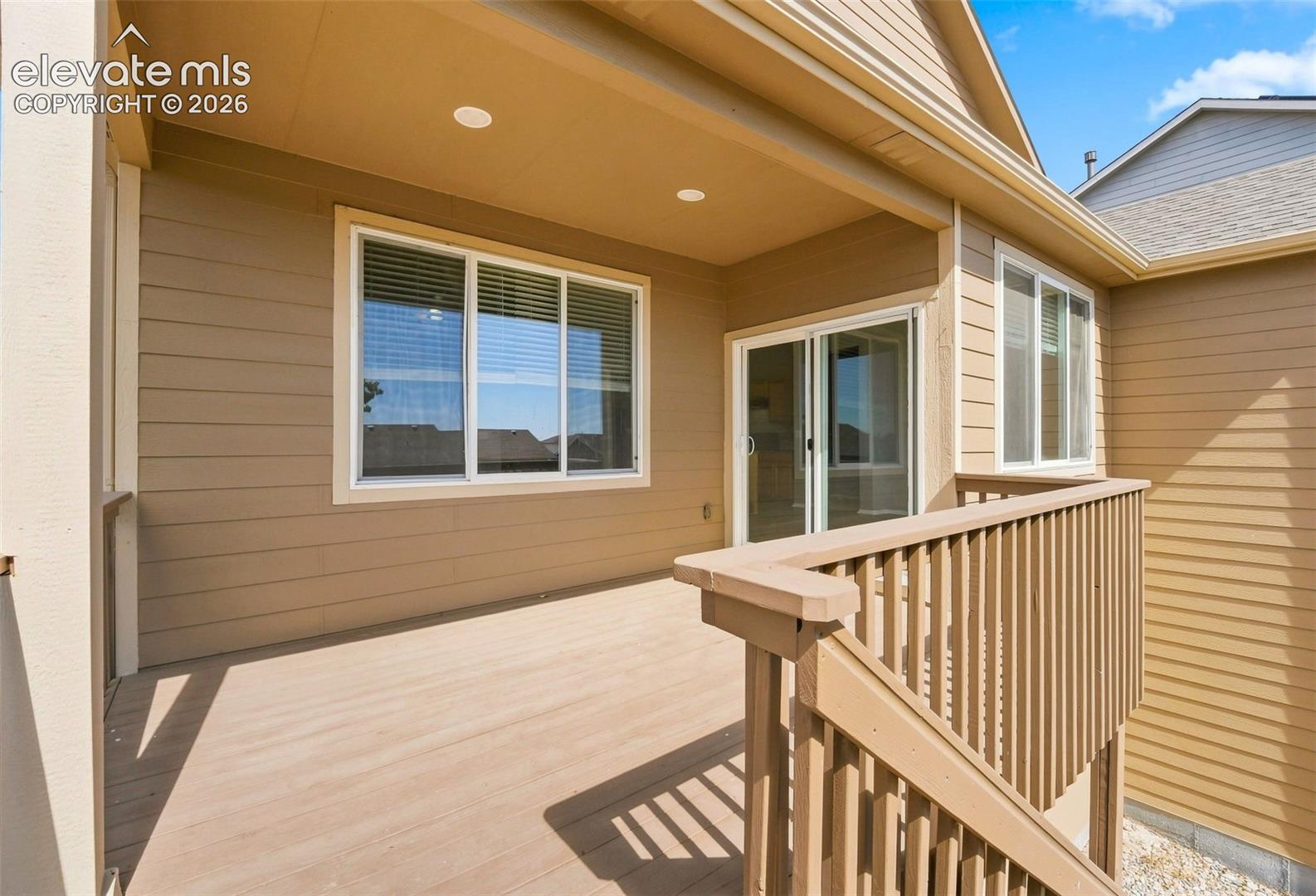 Covered deck featuring composite decking and recessed lighting