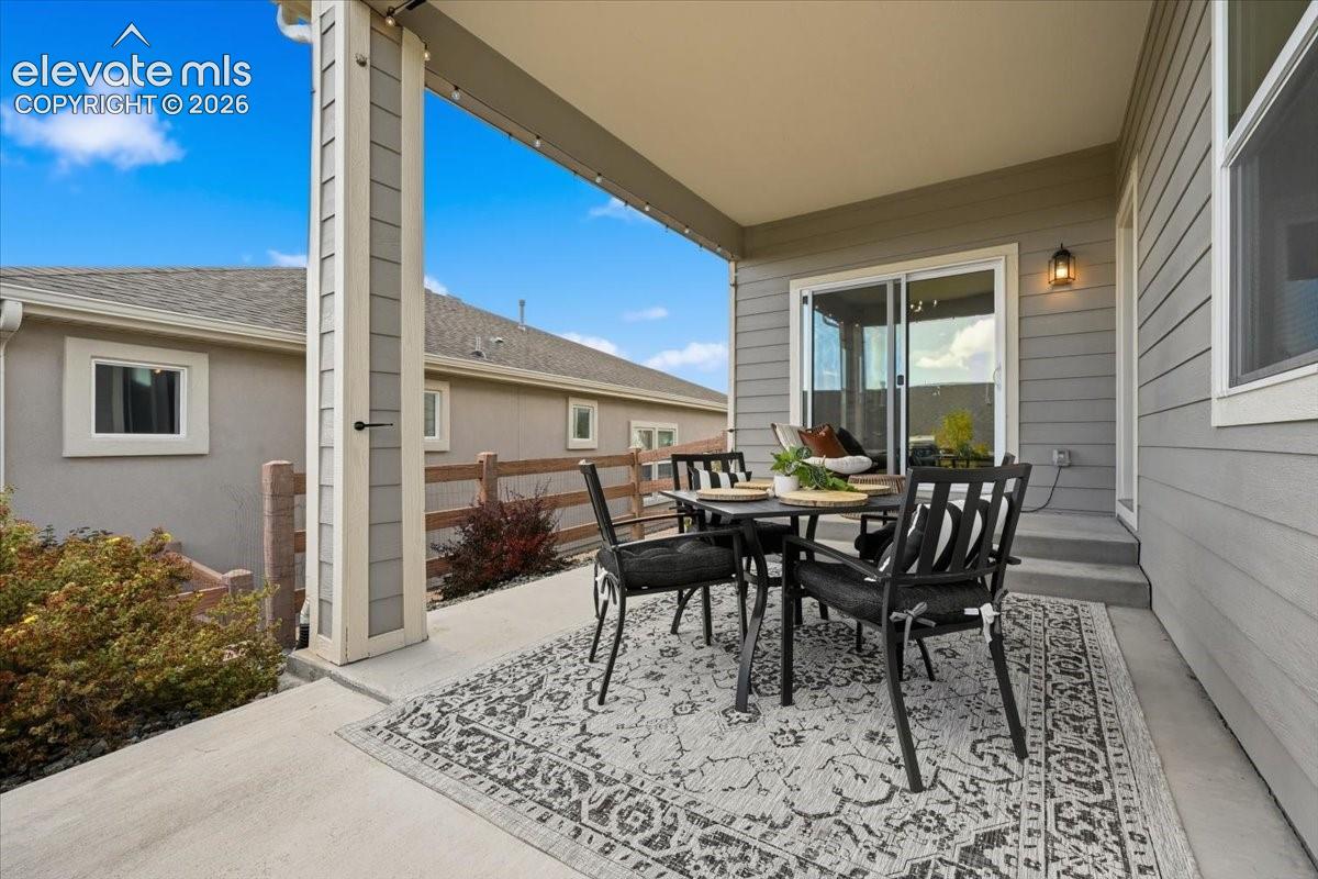 Covered patio with concrete flooring, siding exterior, and sliding glass door access