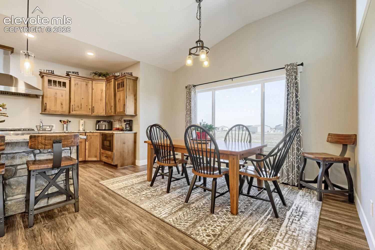 Vaulted ceilings complement the open-concept dining area with large windows