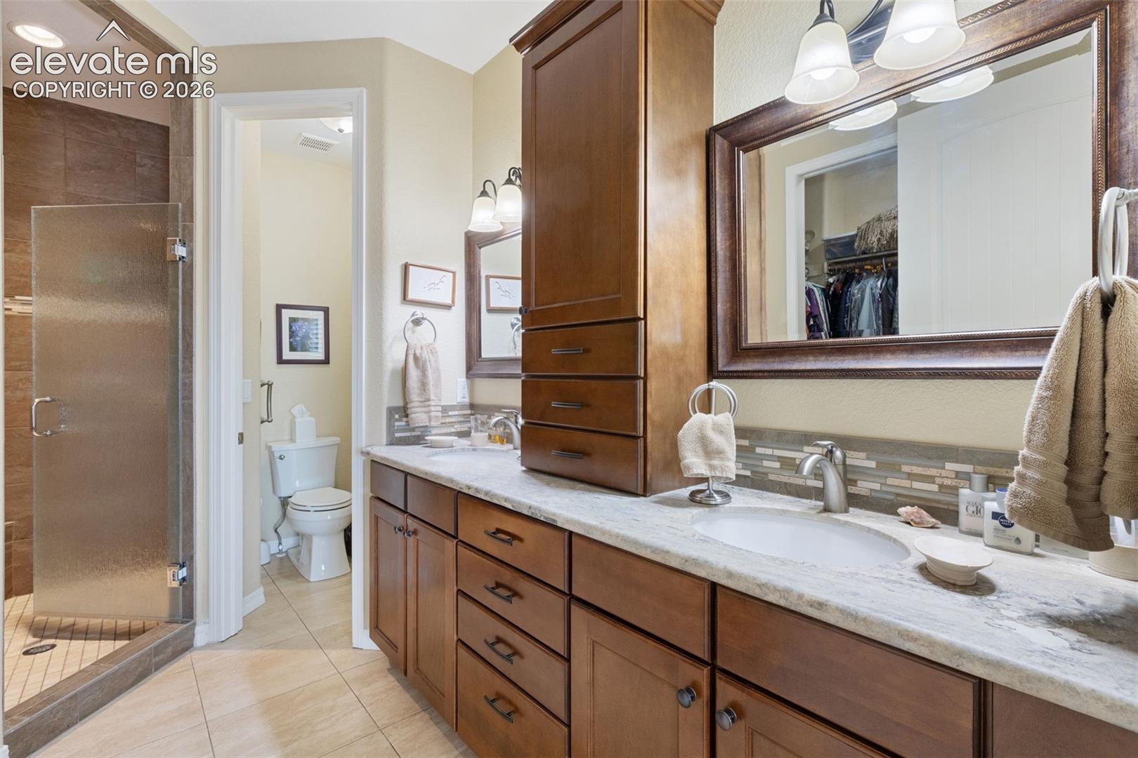 Dual vanity with birch cabinetry.