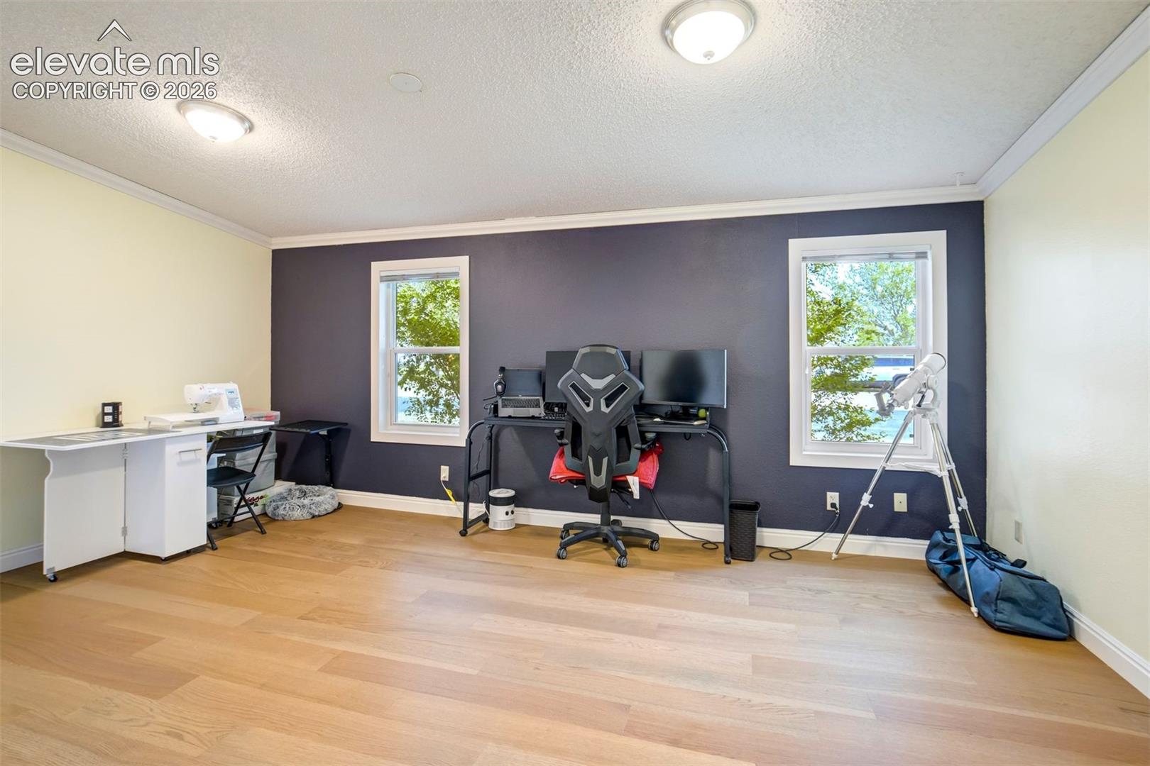 Expansive primary bedroom offers flexibility for additional seating or workspace.