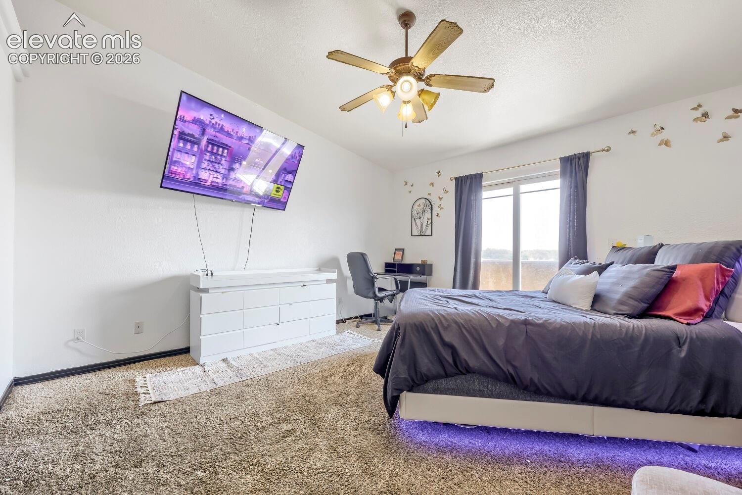 Sloped ceiling with ceiling fan and overhead lighting