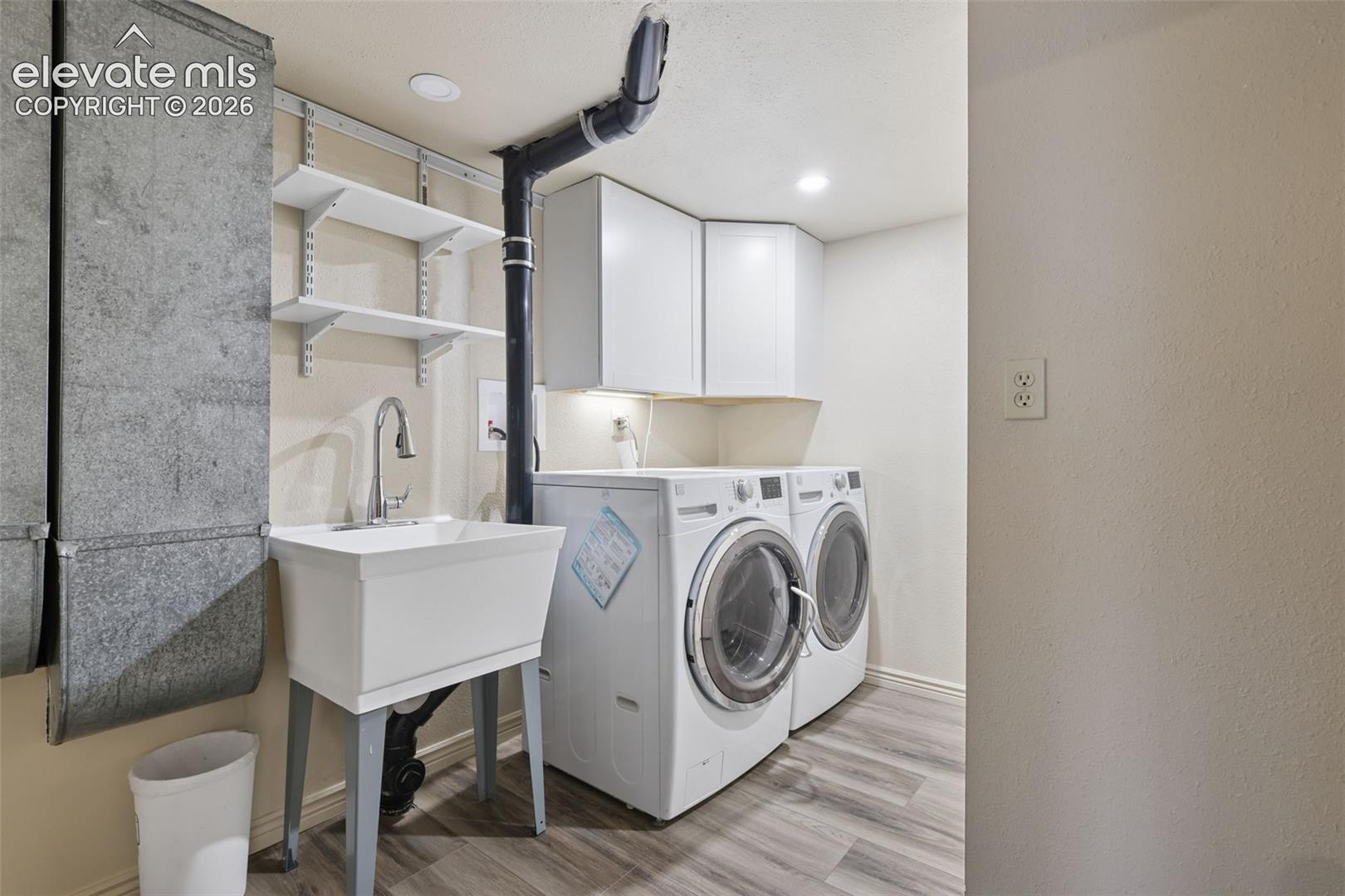 Nice spacious laundry and mud room with laundry/utility sink