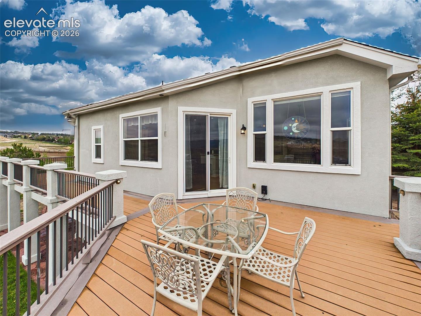 Spacious outdoor deck with direct access from the kitchen, ideal for relaxing or hosting gatherings while enjoying the scenic surroundings.