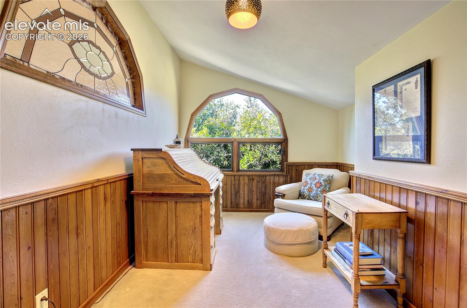 Distinctive stained-glass detail brings artistry + individuality to the upper level office.