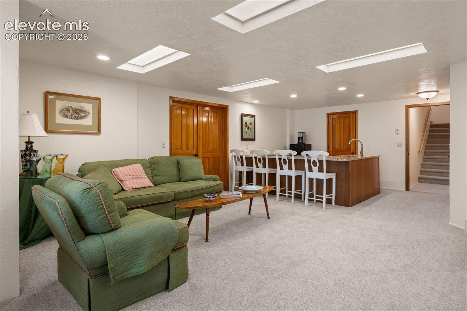 Exceptional in-law suite or separate living potential in lower level, featuring its own exterior entrance plus a lockable interior door connecting to the main living level, with kitchenette, bedroom, and bathroom. 