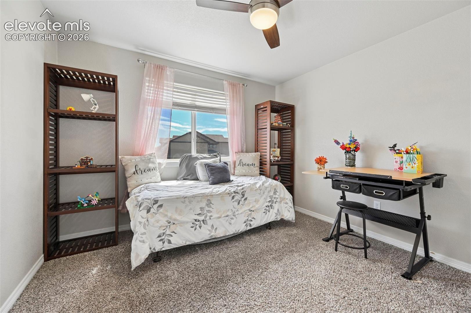 Recessed window with blinds, ceiling fan with light fixture, and plush carpeting