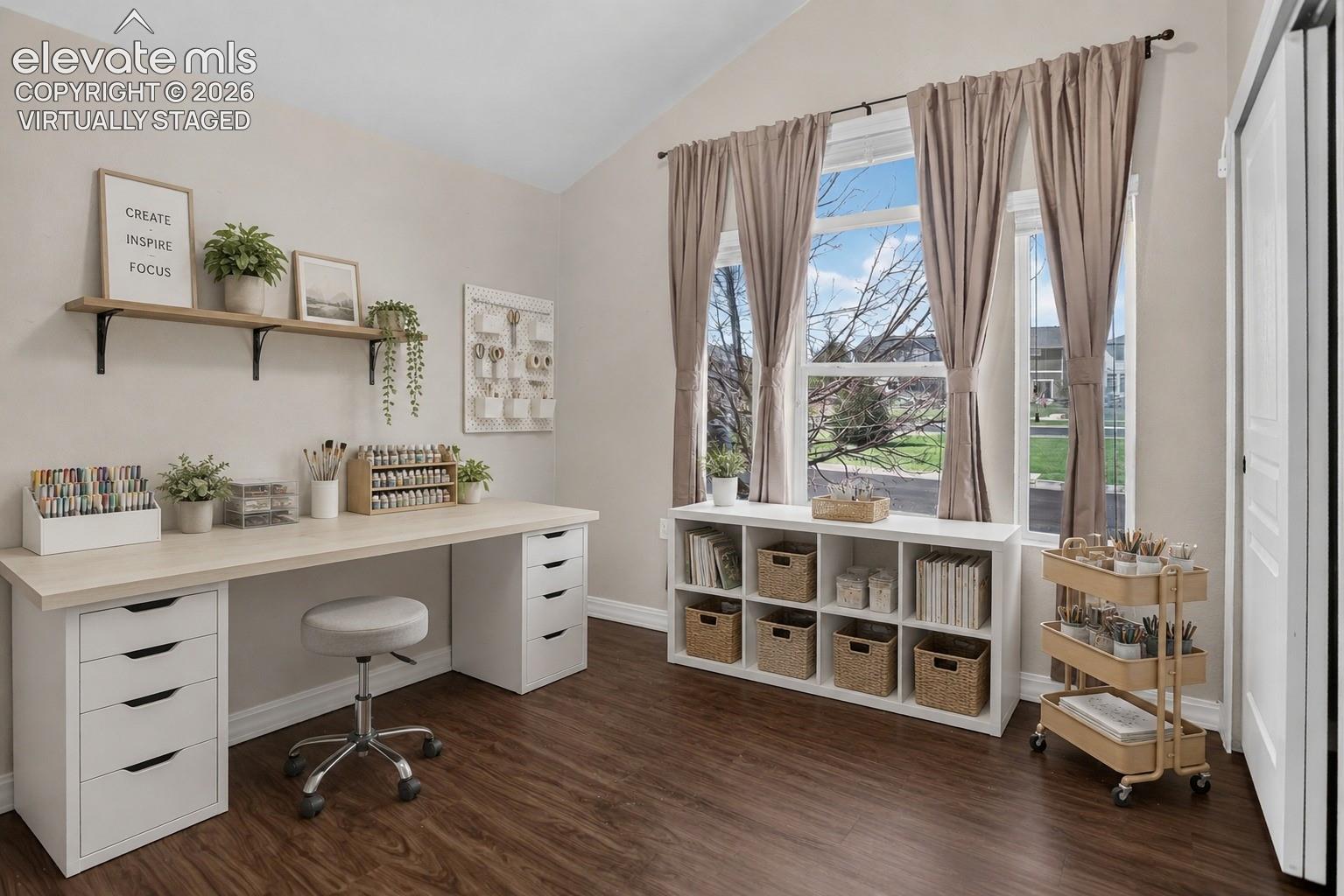 Virtually Staged - Vaulted ceiling, durable wood-finish flooring, built-in shelving, expansive windows, and a built-in desk with drawer storage