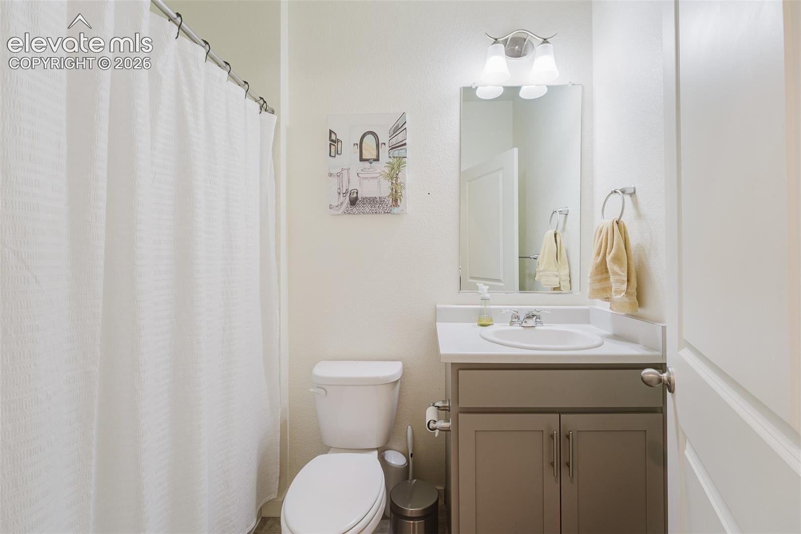 Main Level Full Bathroom with vanity, mirror, and tub/shower.