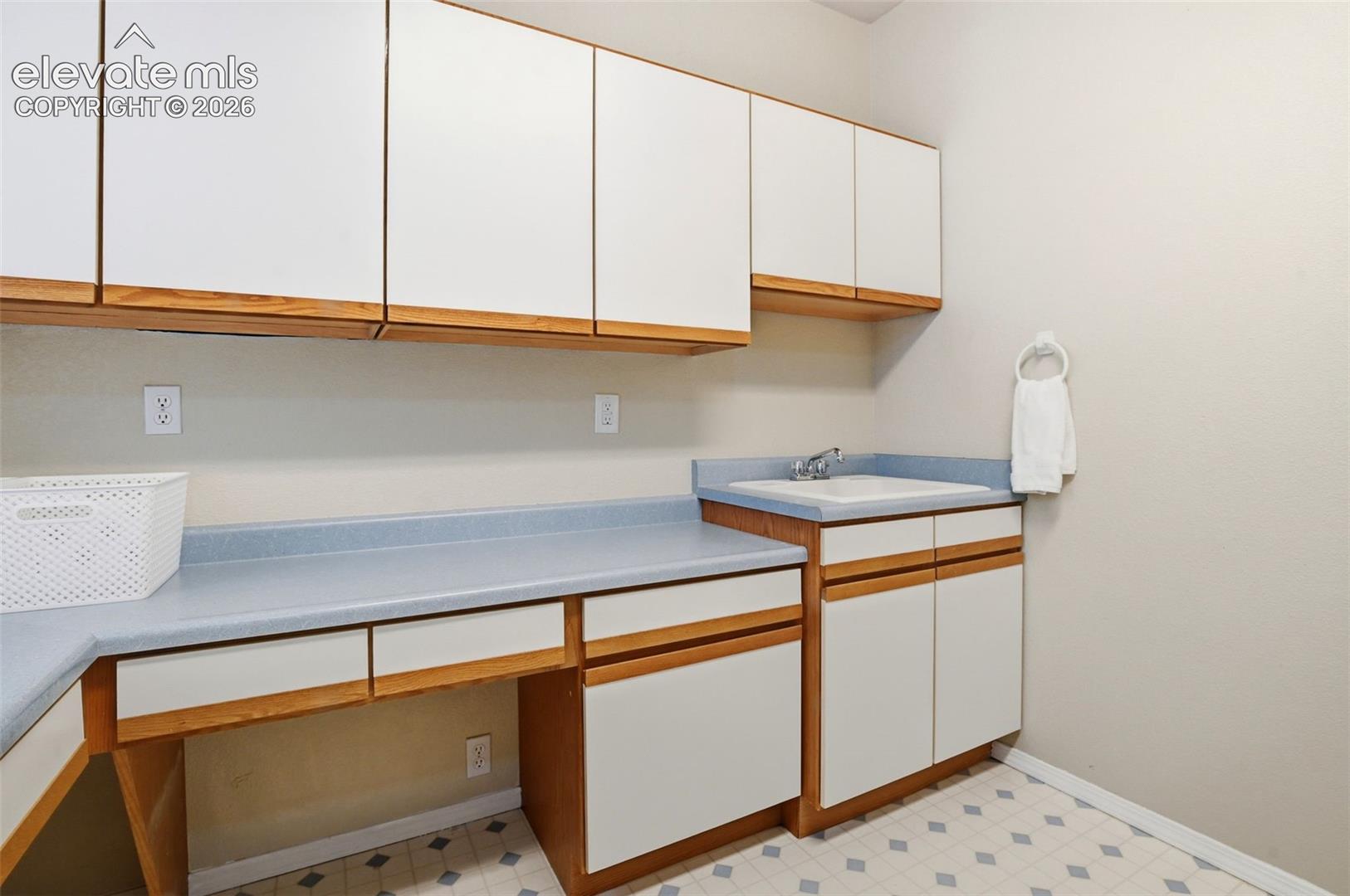 Big main level laundry  with a utility sink, tons of storage, a walk-in pantry, and a big walk-in pantry!