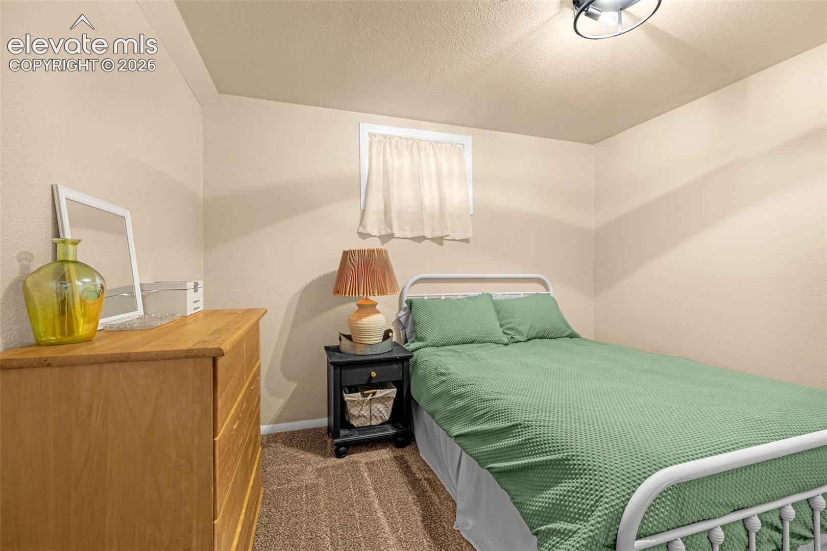 Basement Bedroom with recessed window with white trim