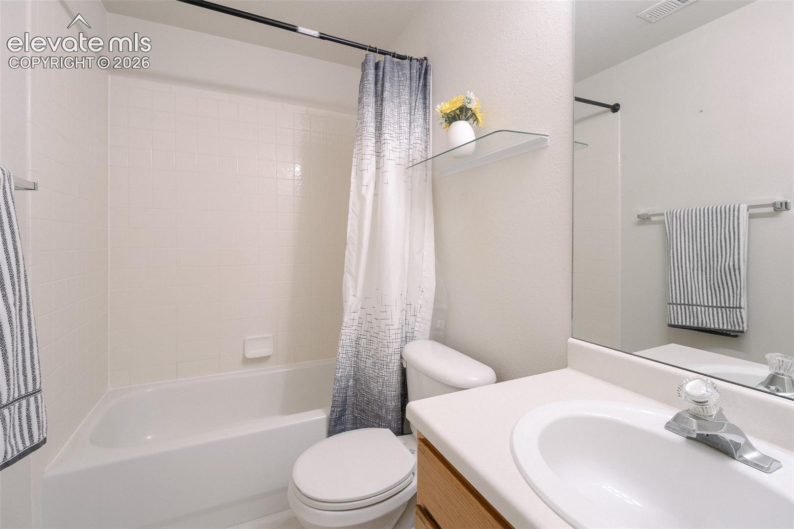 The Basement Bathroom features a vanity, mirror, and tiled tub/shower.