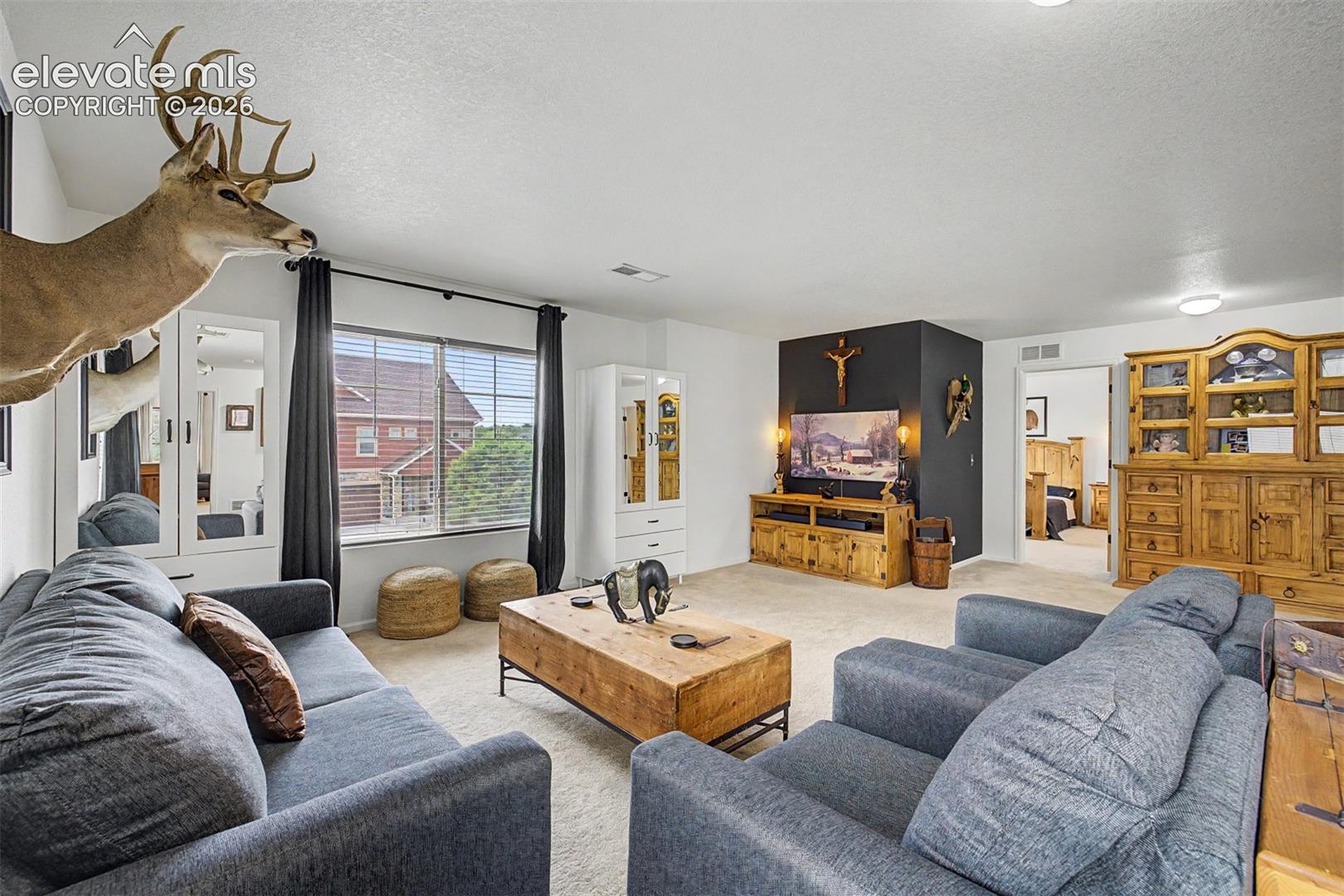 This light-filled loft space with wide windows and generous square footage could serve as a second living room, playroom, home office, or anything the next owner envisions.