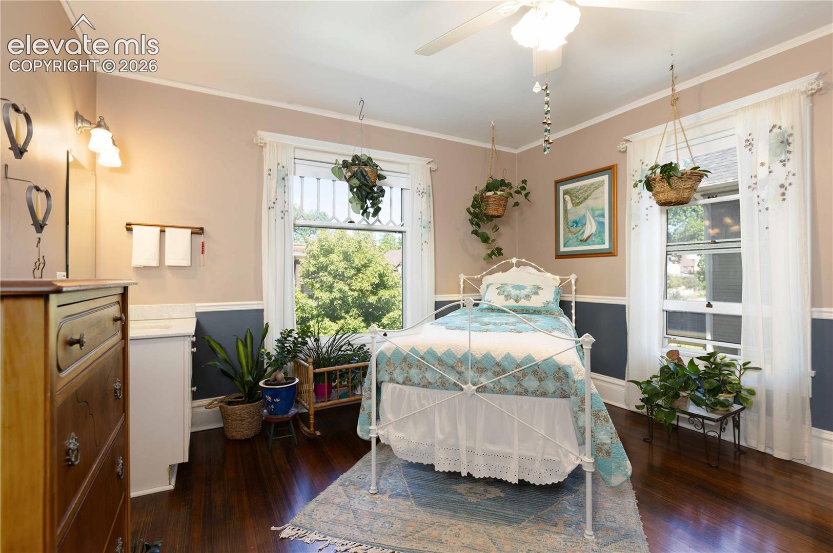 Large windows face forward from this bedroom