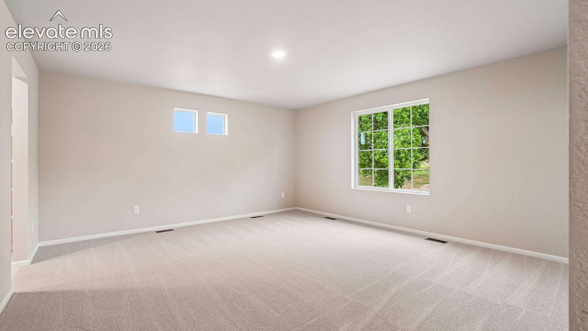 Bright, generously proportioned room featuring neutral wall finishes, recessed ceiling lighting, and abundant natural light from dual windows
*photos of a model home*