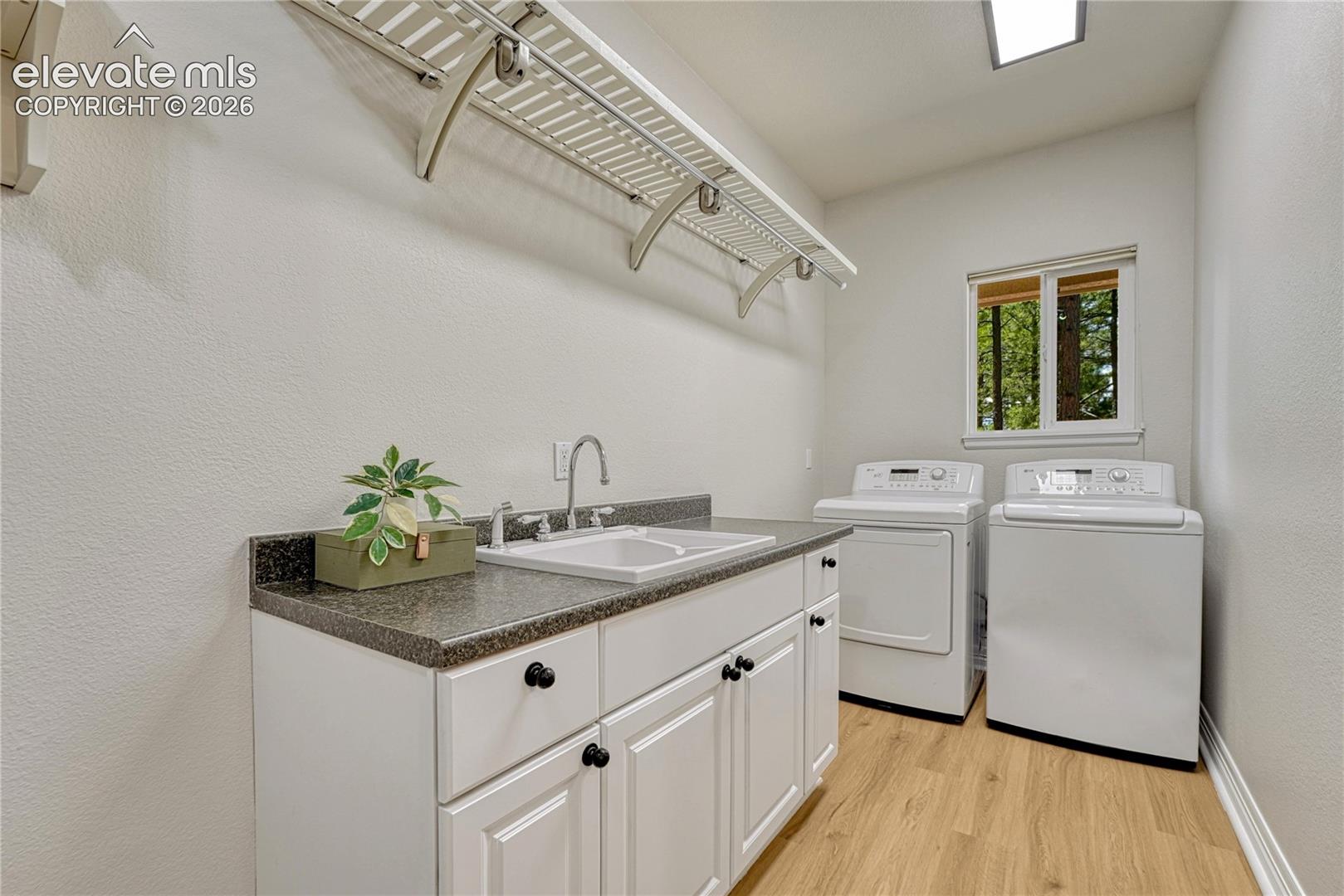 Main level laundry with garage access, utility sink and window. Washer and dryer included!