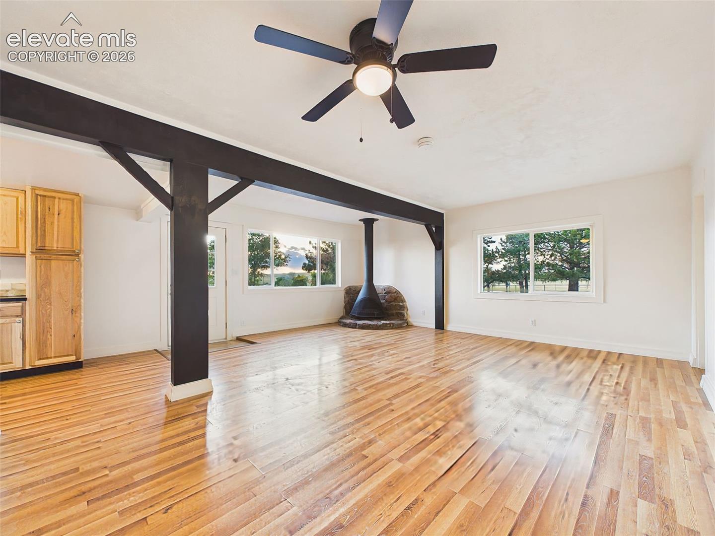 Great Room – Spacious open-concept great room, exposed beams, updated laminate flooring, and abundant natural light.