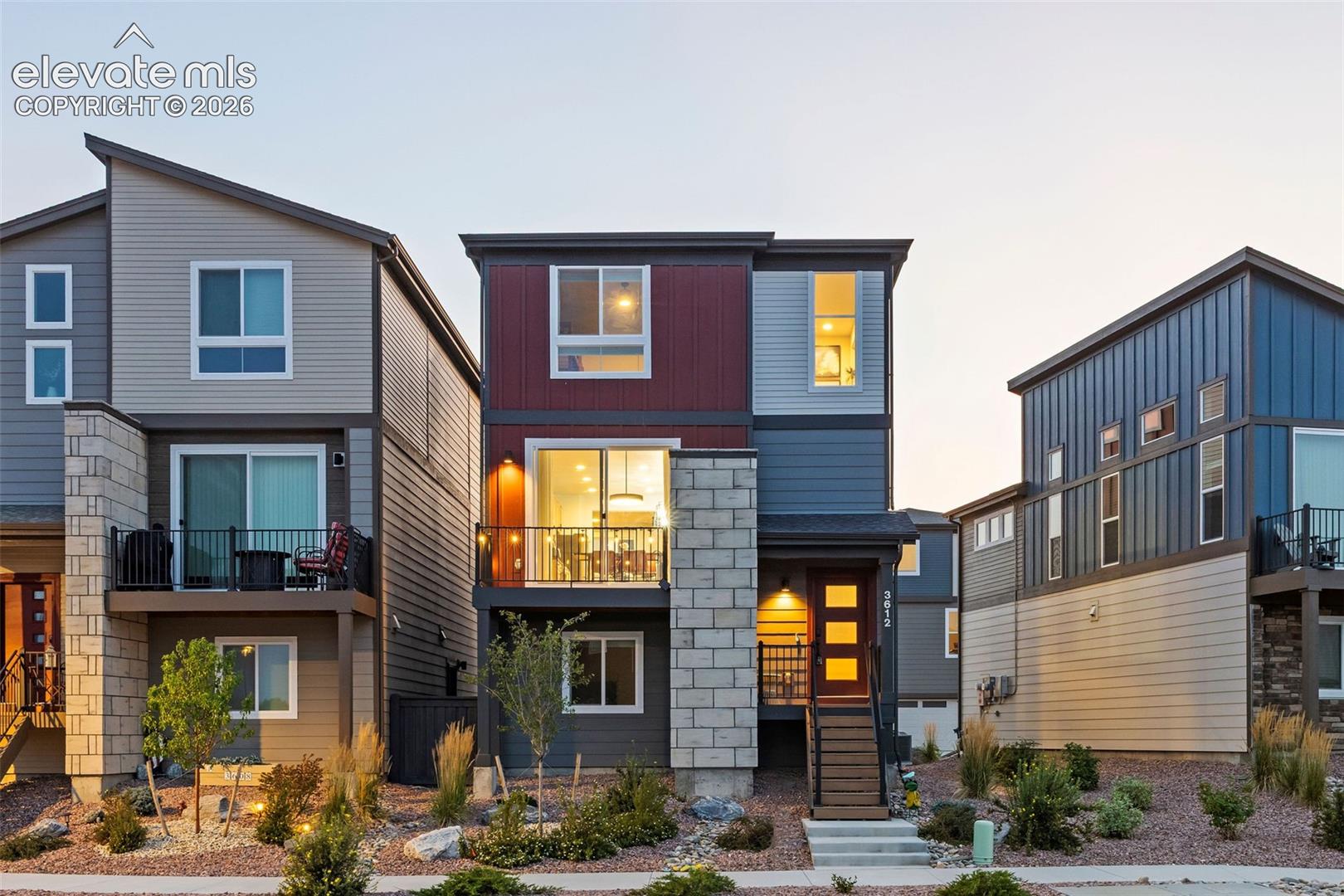 This home is an eye-catcher with its' red and gray exterior and stonework. SO PRETTY!