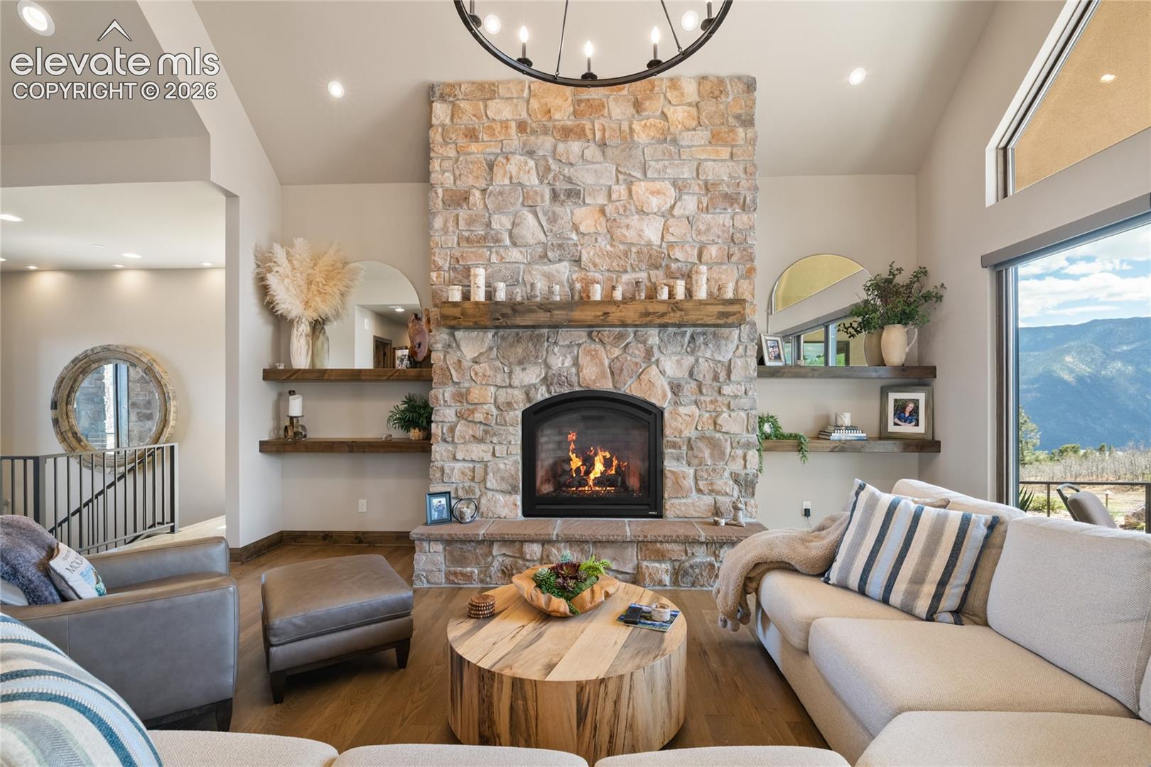 Floor-to-ceiling stonework. Hand-hewn mantel. Mountain views out every window. This isn't just a living room, it's the room where everyone ends up.