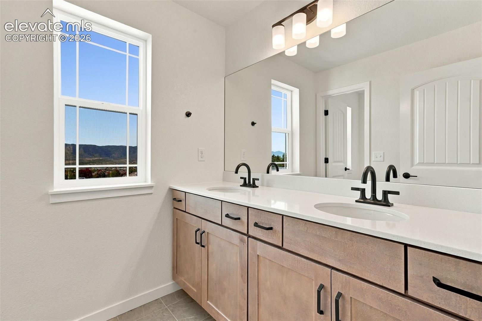 The Full Hall Bath Includes a double vanity with undermount sinks, and a tub/shower combo with additional door to close it off for privacy.