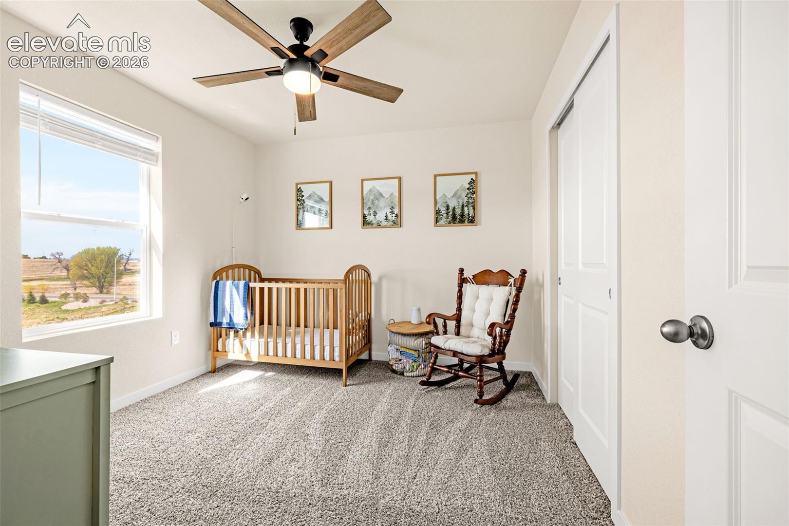 Recessed lighting, wood-finish ceiling fan, large window with blinds, light-colored walls, and carpet flooring